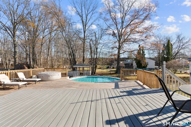 a view of patio with swimming pool and sitting space