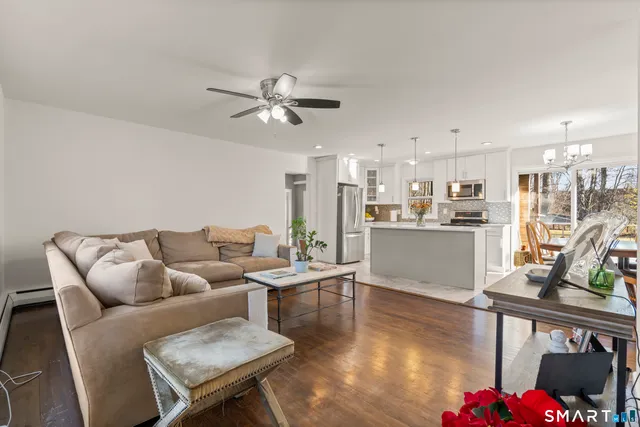 a living room with furniture and kitchen view