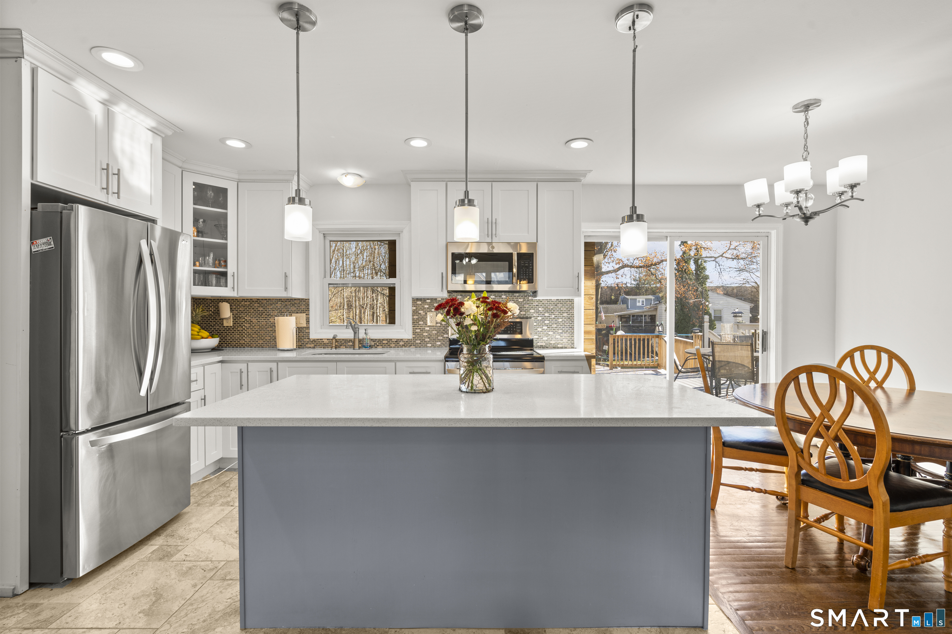 342 West Spring Street West Haven, CT 06516 - Photo 6 of 30 a kitchen with stainless steel appliances granite countertop a refrigerator a sink a stove and a dining table with wooden floor
