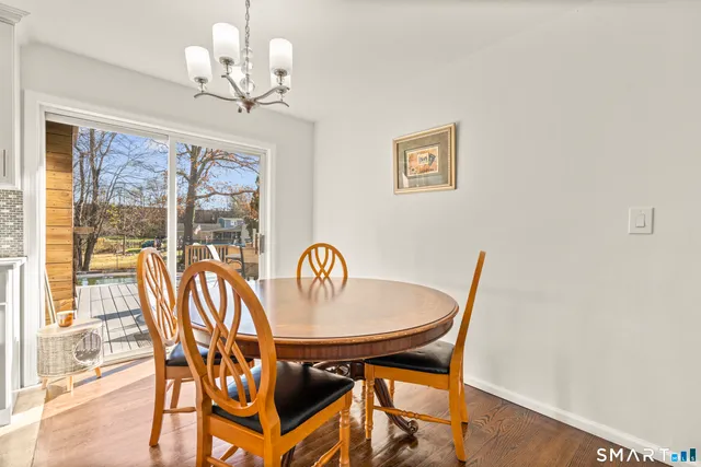 a view of a dining room with furniture wooden floor and chandelier