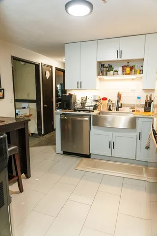 a kitchen with stainless steel appliances granite countertop a sink and cabinets