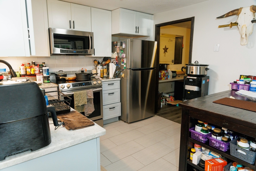 50 Spencer Road, Unit 36L Boxborough, MA 01719 - Photo 12 of 15 a kitchen with stainless steel appliances granite countertop a sink stove and refrigerator