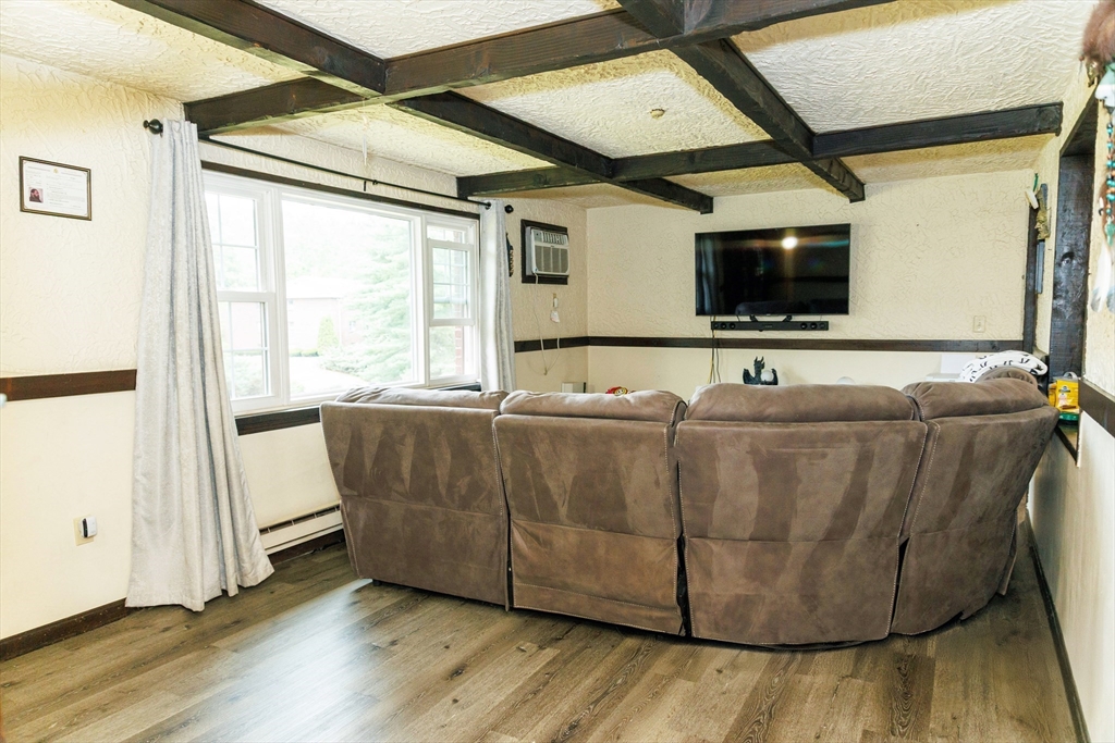 50 Spencer Road, Unit 36L Boxborough, MA 01719 - Photo 4 of 15 a living room with furniture and a flat screen tv