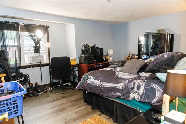 a bedroom with bed and glass door