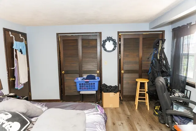a living room with furniture a flat screen tv and a window