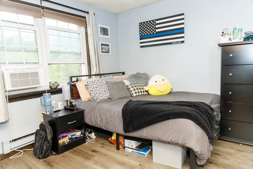 50 Spencer Road, Unit 36L Boxborough, MA 01719 - Photo 9 of 15 a bedroom with a bed and wooden floor