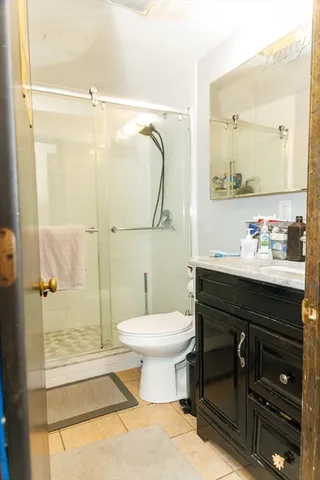 a bathroom with a sink vanity mirror and toilet