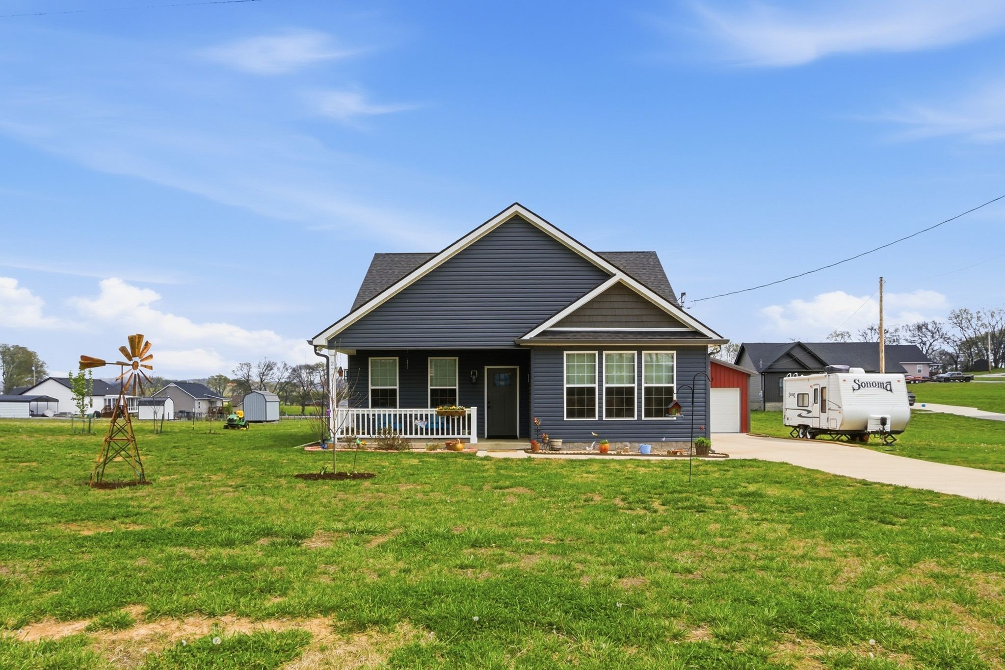 2705 Mc Connell Road Cornersville, TN 37047 - Photo 10 of 41 a front view of a house with a yard table and chairs