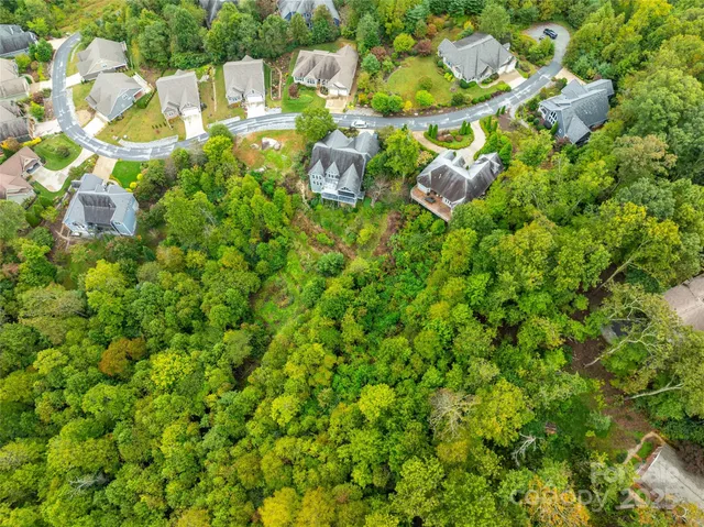a close up of a white house with a yard and plants