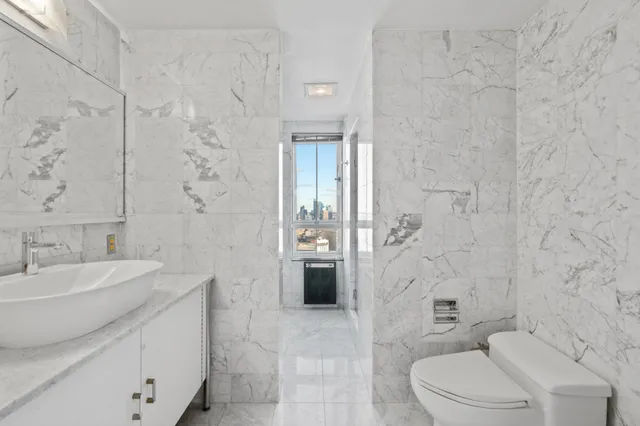 a bathroom with a toilet sink and shower