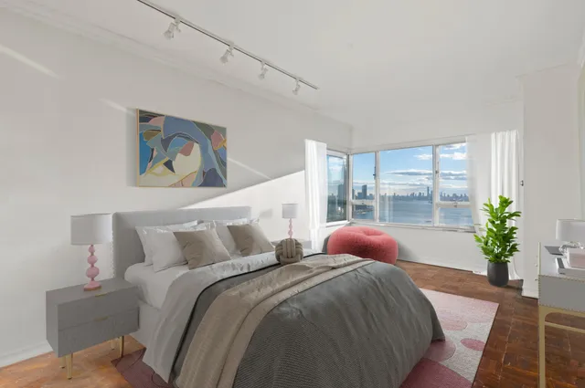 a bedroom with a bed and a potted plant