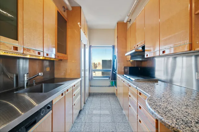 a kitchen with stainless steel appliances kitchen island granite countertop a sink and a stove