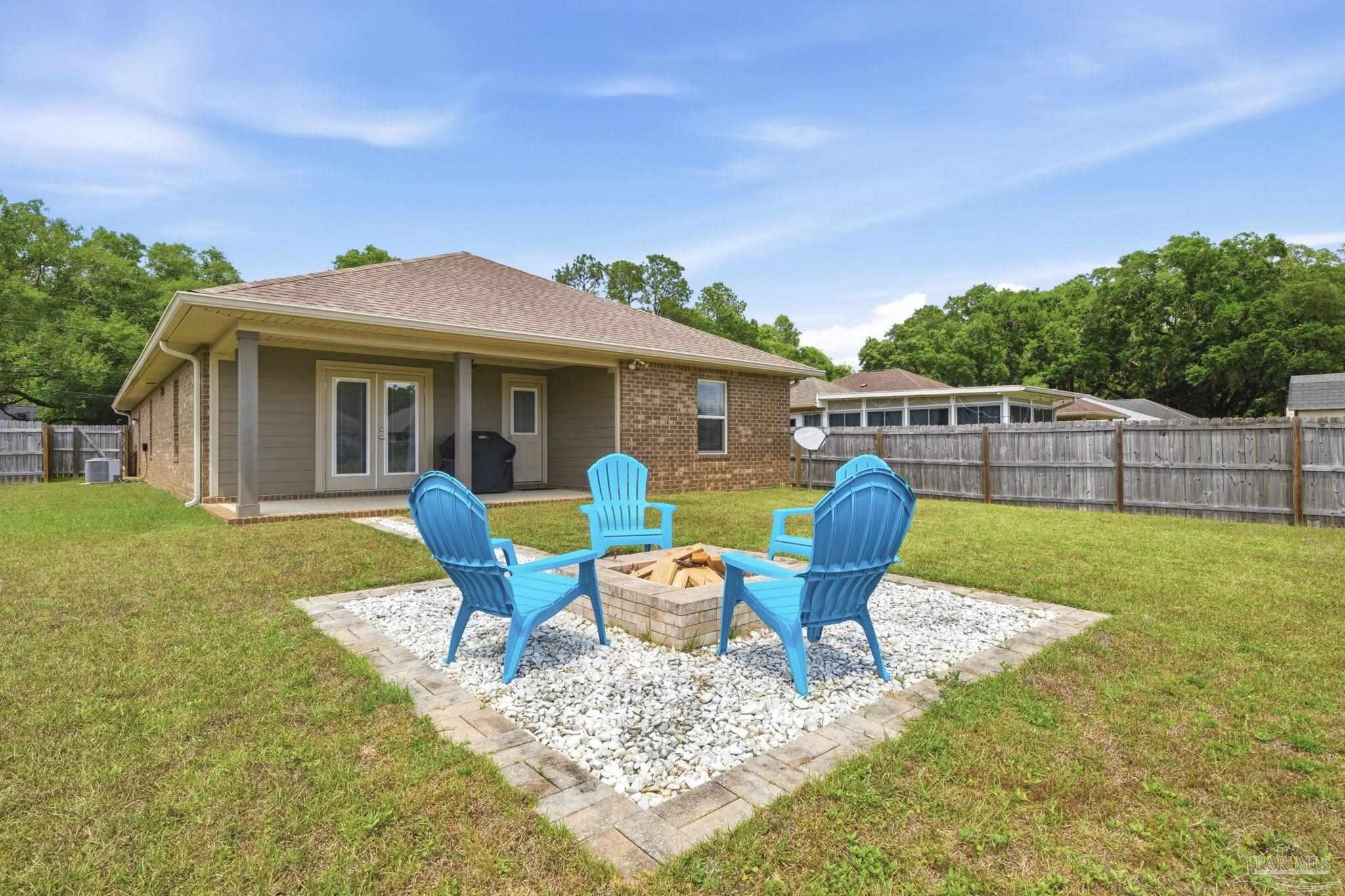 3859 Adams Road Pace, FL 32571 - Photo 22 of 26 a chairs and table in front of house