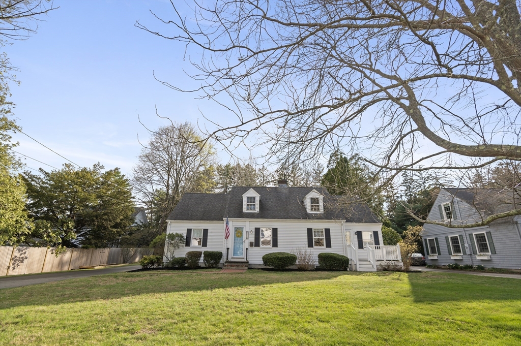 110 Linden Street Hamilton, MA 01982 - Photo 2 of 25 a front view of a house with a yard and large trees