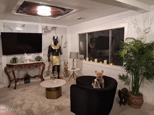 a living room with furniture a flat screen tv and a potted plant