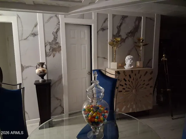 a room with wooden floor and a potted plant