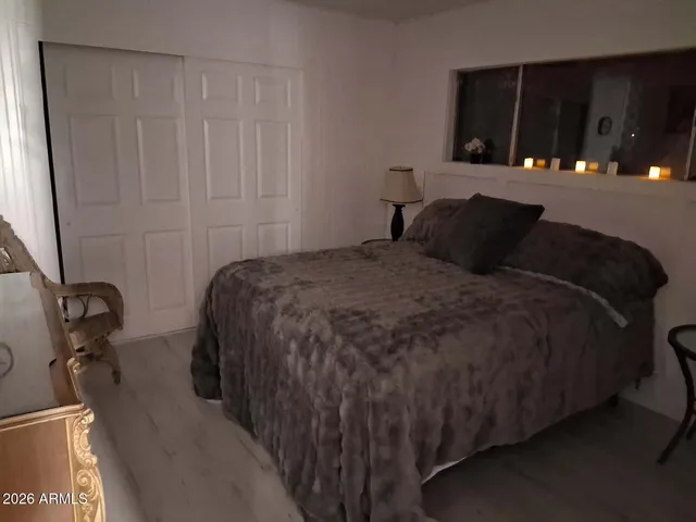 a bedroom with a bed and a window