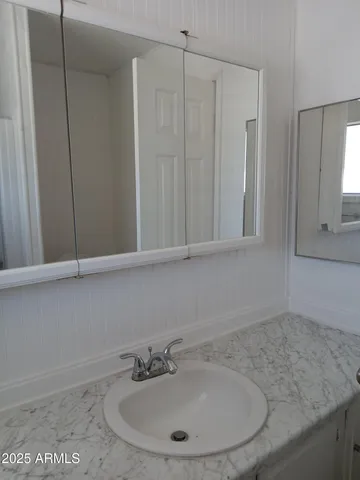 a bathroom with a sink and vanity