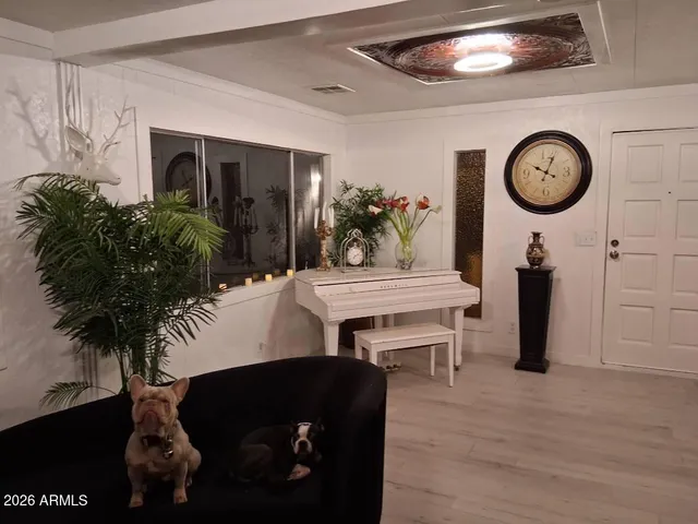 a living room with furniture and a clock