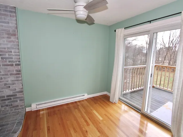 a view of a room with wooden floor and windows