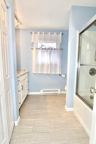 a view of bathroom with bathtub and shower