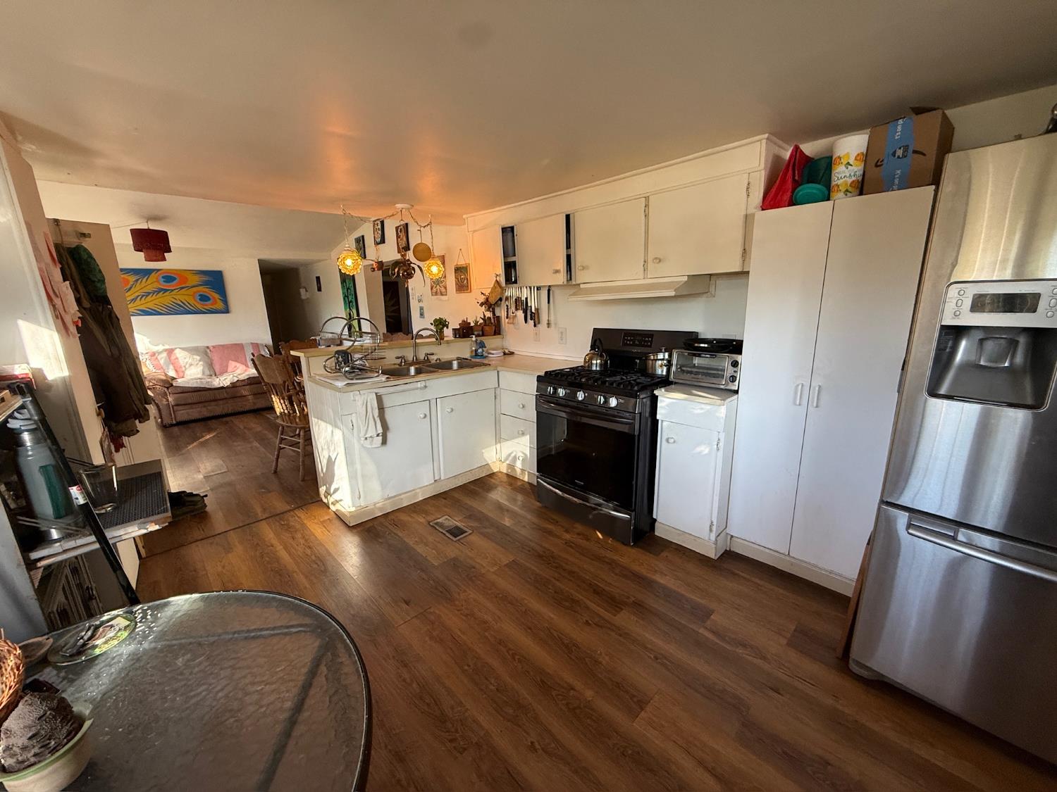 21614 Rockaway Road Nevada City, CA 95959 - Photo 27 of 56 a kitchen with granite countertop a refrigerator stove and wooden floor
