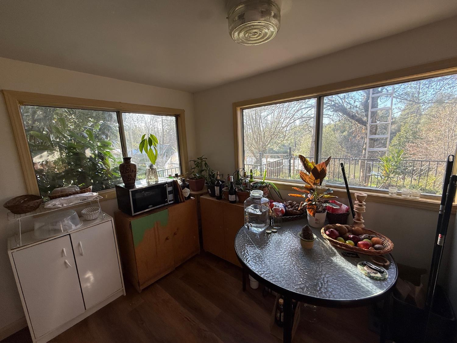 21614 Rockaway Road Nevada City, CA 95959 - Photo 28 of 56 a view of a dining room with furniture large windows and wooden floor