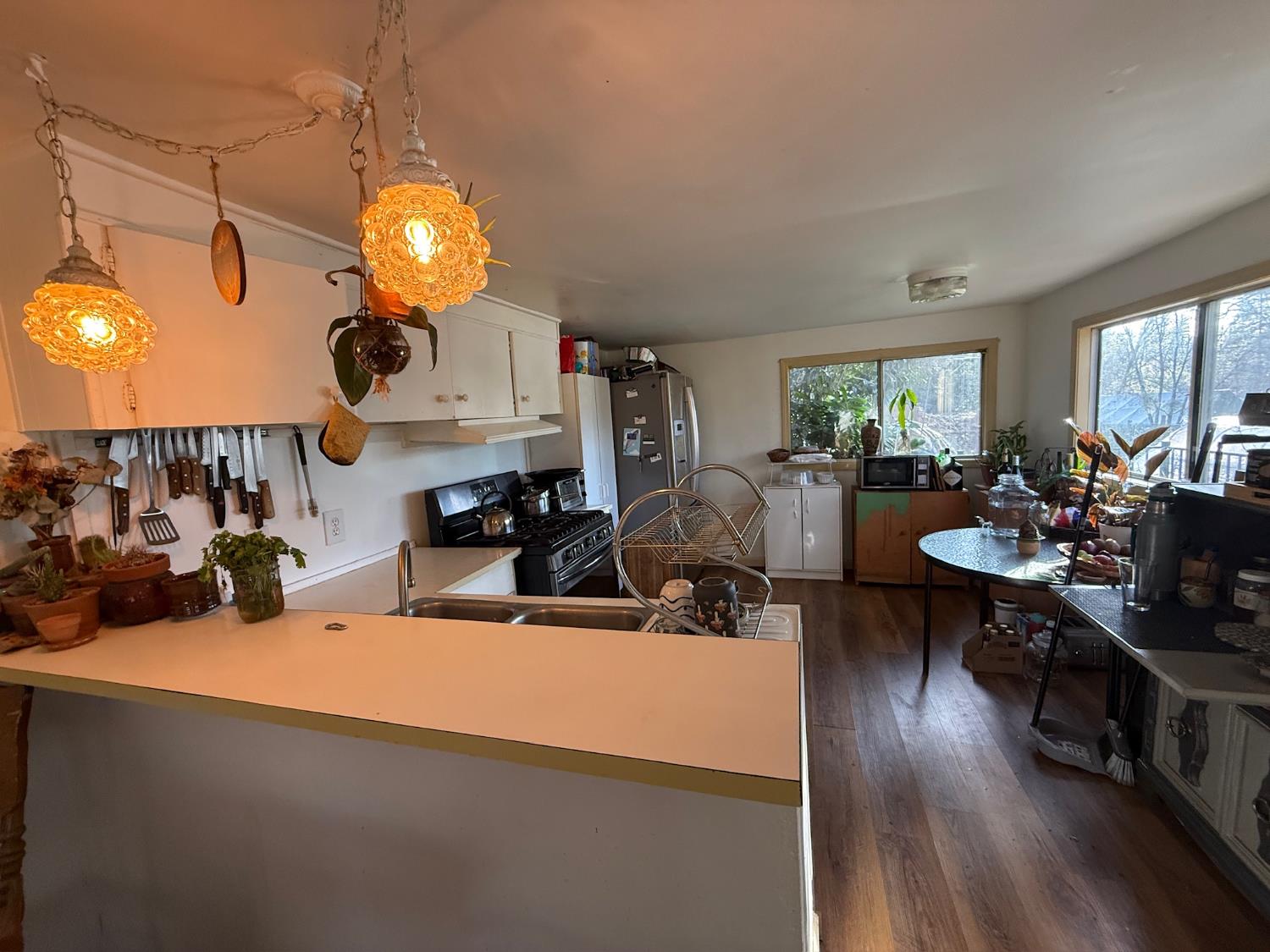 21614 Rockaway Road Nevada City, CA 95959 - Photo 29 of 56 a view of a dining room and livingroom with furniture wooden floor a rug and a chandelier