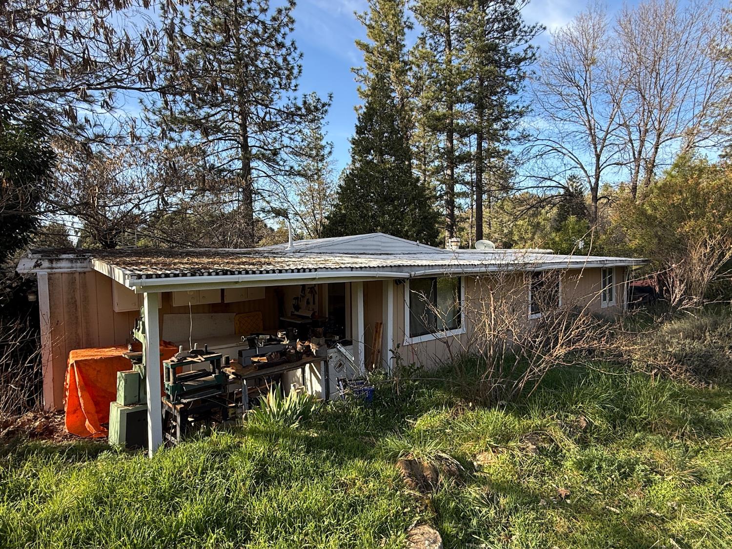 21614 Rockaway Road Nevada City, CA 95959 - Photo 54 of 56 a view of a patio with table and chairs potted plants and large tree