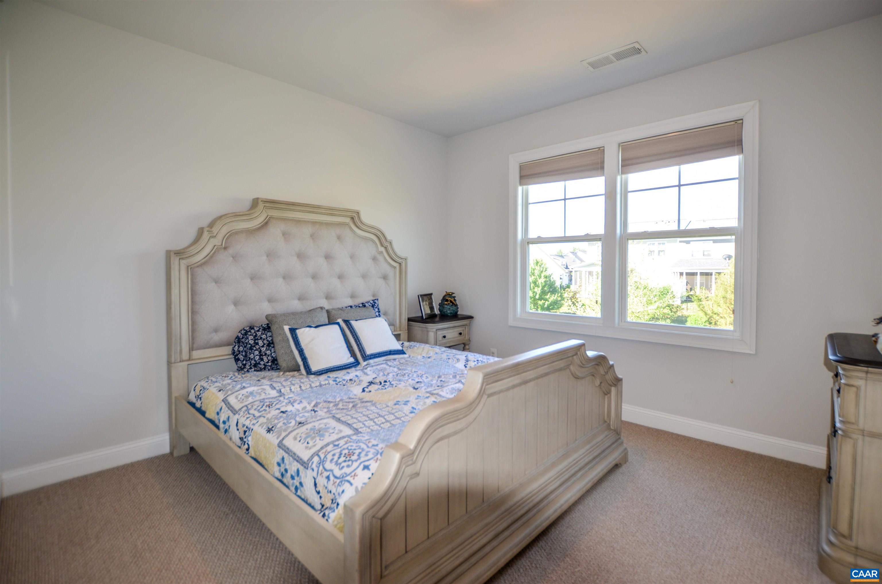 327 Claibourne Road Crozet, VA 22932 - Photo 29 of 36 a bed sitting in a bedroom next to a window