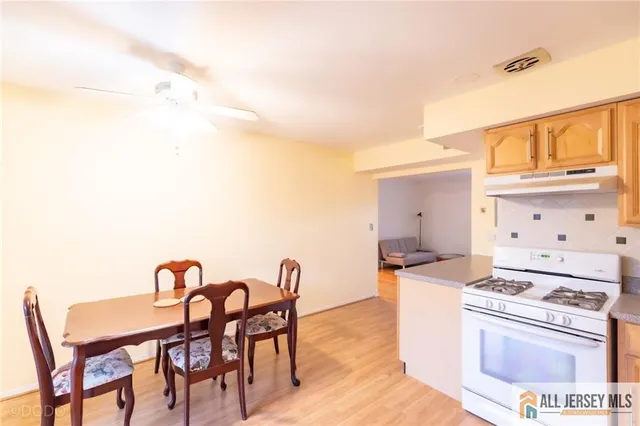 a dining room with furniture and wooden floor