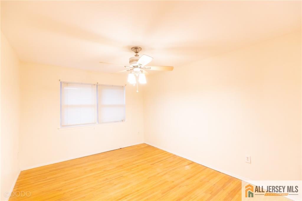 187 Evergreen Road, Unit 4B Edison, NJ 08837 - Photo 6 of 8 a view of empty room with wooden floor