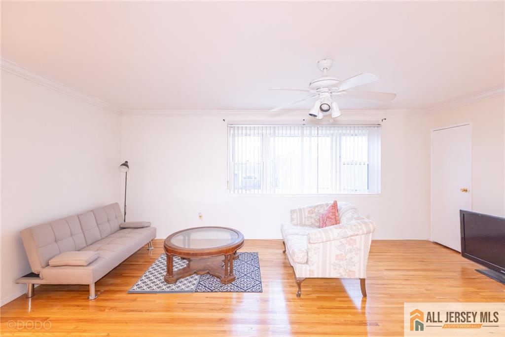 187 Evergreen Road, Unit 4B Edison, NJ 08837 - Photo 7 of 8 a living room with furniture and a table