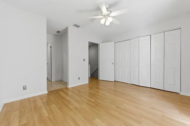 a view of empty room with wooden floor