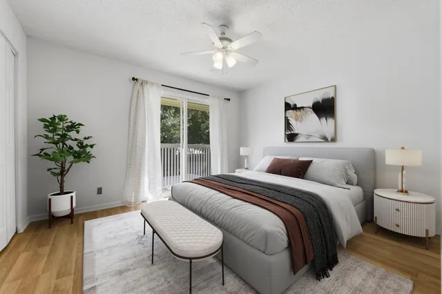 a spacious bedroom with a bed and a potted plant