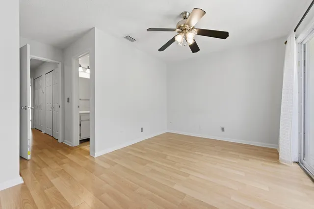 a view of a room with wooden floor and white walls