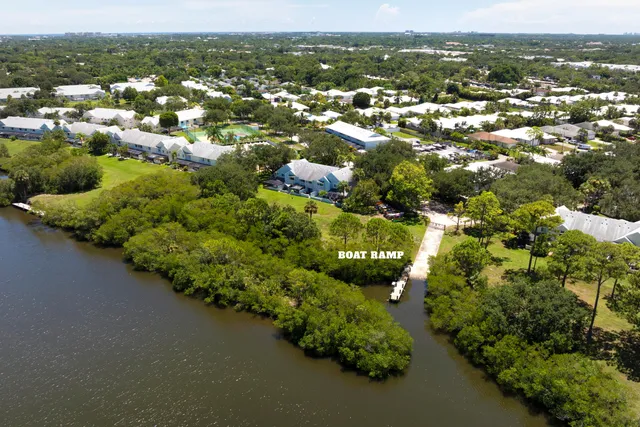 an aerial view of residential houses with outdoor space and trees