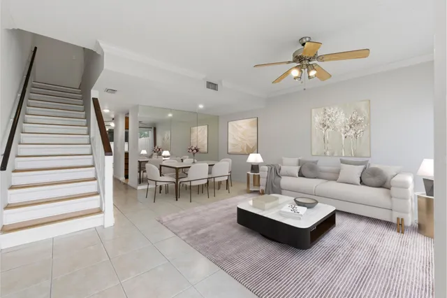 a living room with furniture a rug and white walls