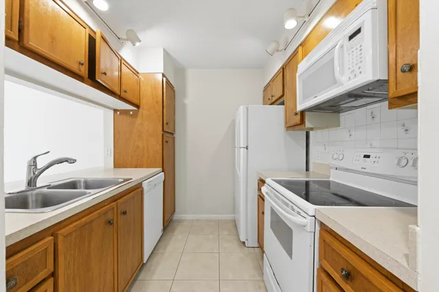 a kitchen that has a sink and a stove