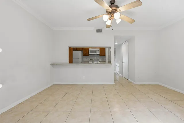 a view of a kitchen with a sink and a chandelier fan