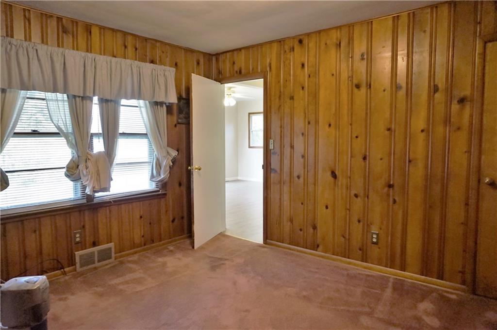 1304 South Main Street Butler, PA 16001 - Photo 17 of 25 Third bedroom with a wood theme and used as a main floor laundry. Could be easily converted to a bedroom.