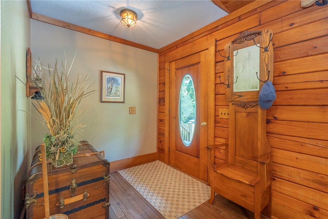 911 State Rd S-4-203 Belton, SC 29627 - Photo 8 of 49 A welcoming entryway with natural wood paneling and elegant hardwood flooring.
