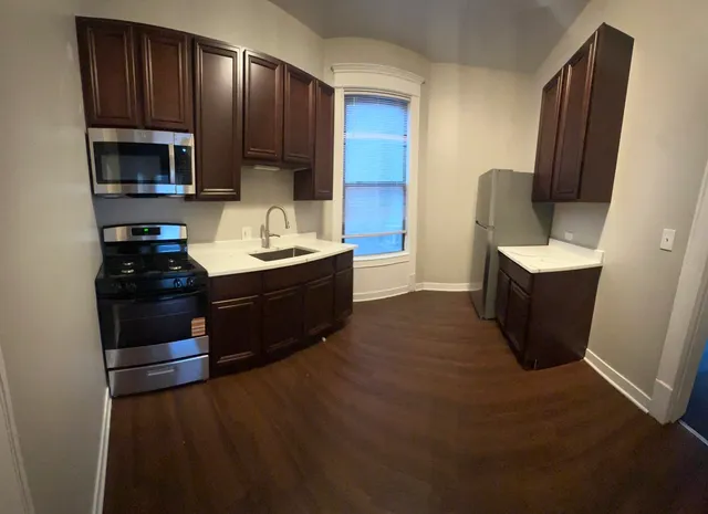 a kitchen with a sink and a refrigerator