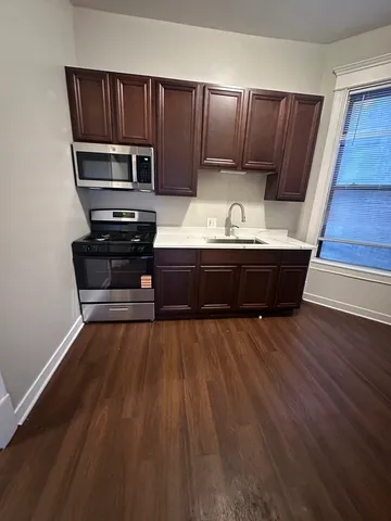 a room with wooden floors and furniture
