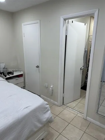 a bedroom with a bed and a mirror