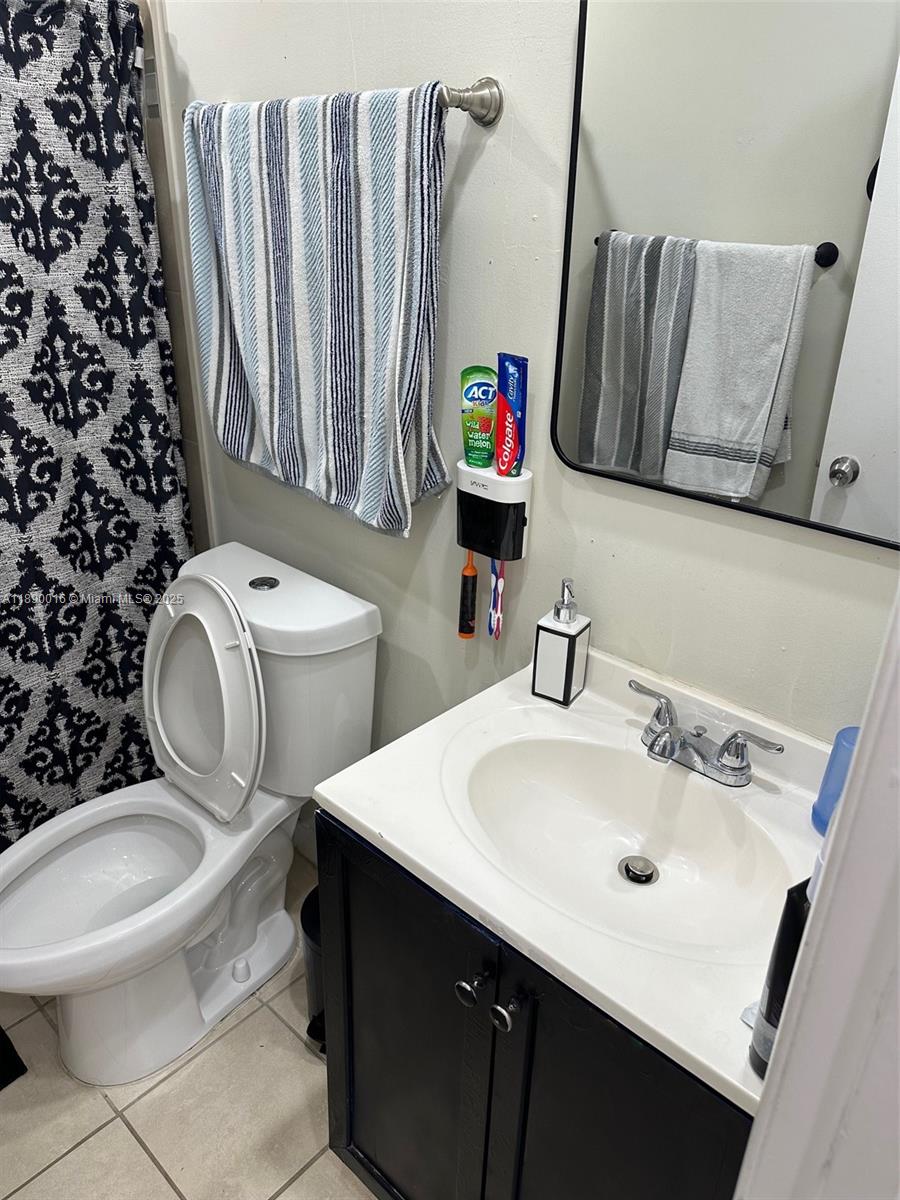 11301 Southwest 200th Street, Unit 305A Miami, FL 33157 - Photo 13 of 26 a bathroom with a sink toilet and shower