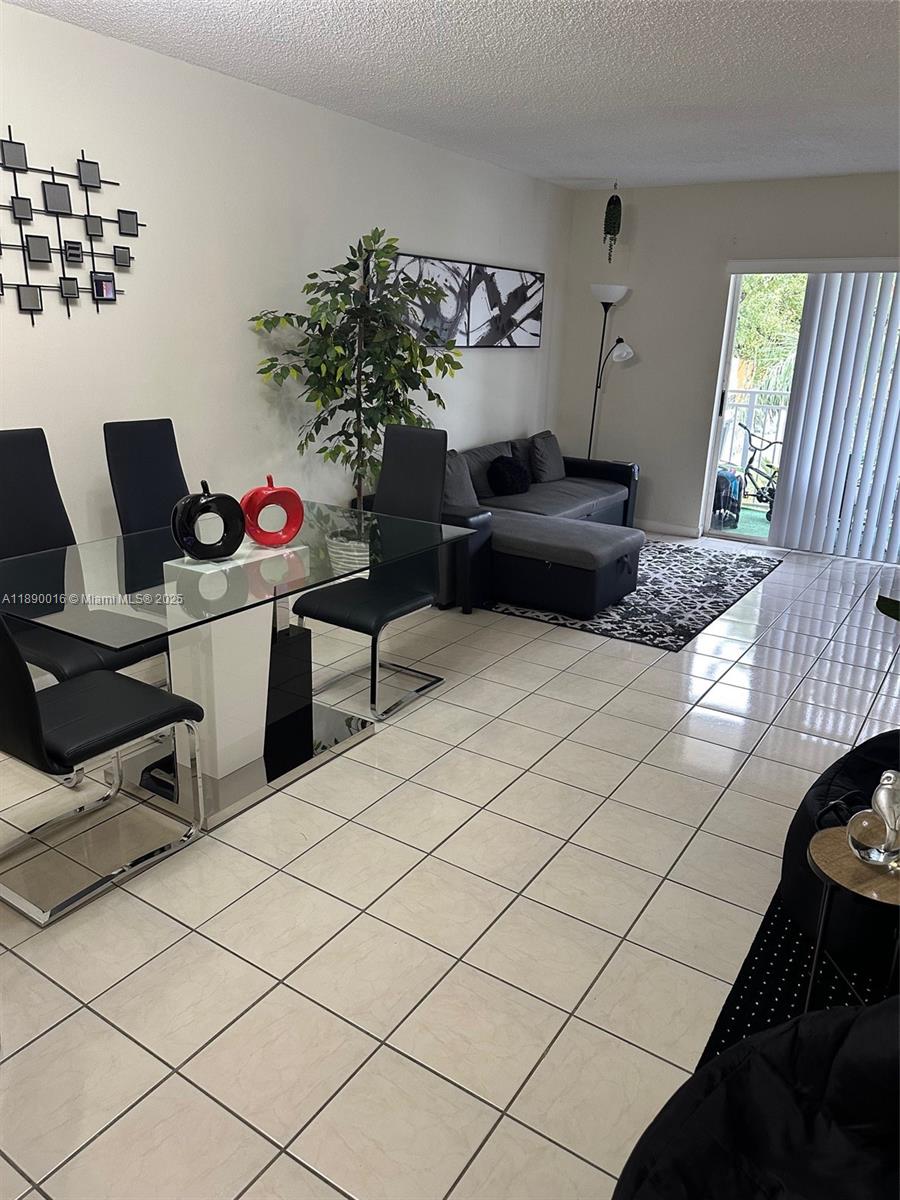 11301 Southwest 200th Street, Unit 305A Miami, FL 33157 - Photo 15 of 26 a living room with furniture and a potted plant