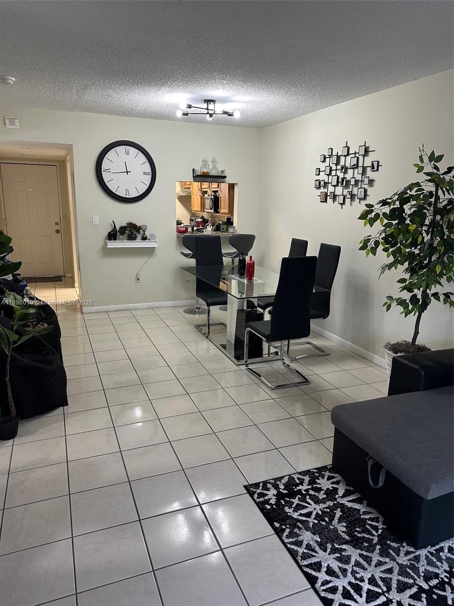 11301 Southwest 200th Street, Unit 305A Miami, FL 33157 - Photo 17 of 26 a living room with furniture and a potted plant