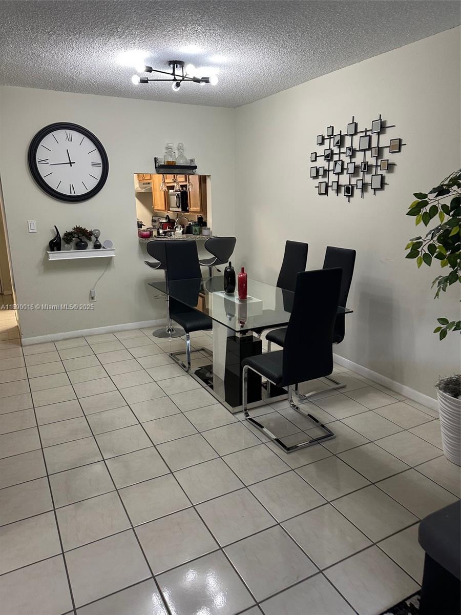 11301 Southwest 200th Street, Unit 305A Miami, FL 33157 - Photo 18 of 26 a view of a workspace with a table and a chair