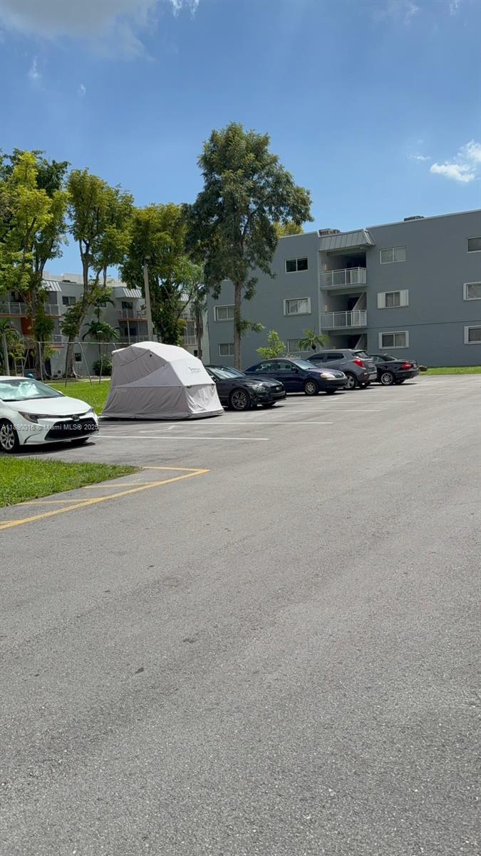 11301 Southwest 200th Street, Unit 305A Miami, FL 33157 - Photo 2 of 26 a car parked on the side of the road